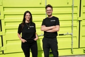 Mollie Claypool and Gilles Retsin in front of a shipping container holding the AUAR micro-factory